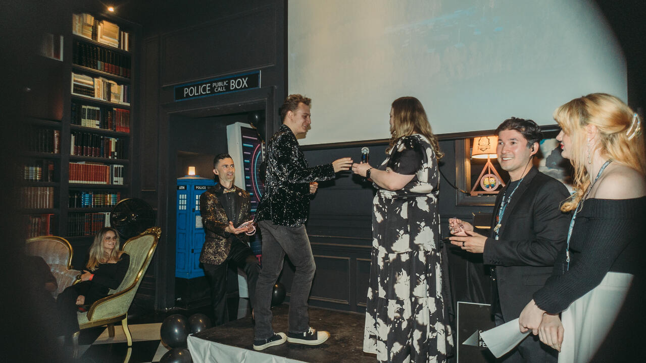JoJo Scanlon accepting the Nevada Filmmaker Award from Nevada Film Board Director Kim Spurgeon at the C-47 Film Festival